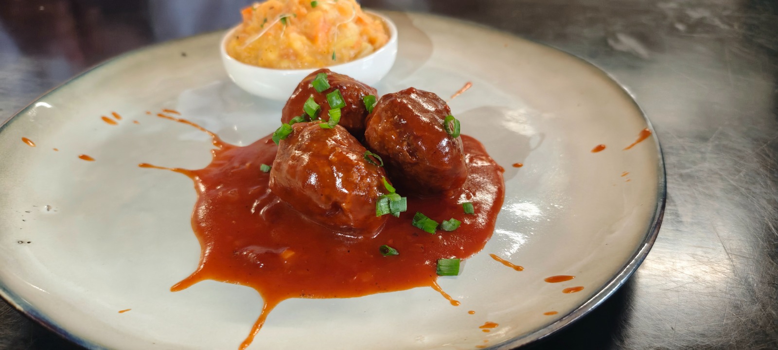 Plato de hutspot con albóndiga y salsa de carne